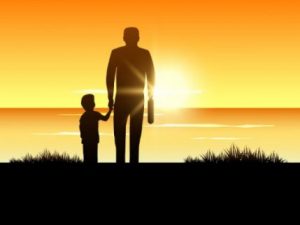 Far och son i solnedgång