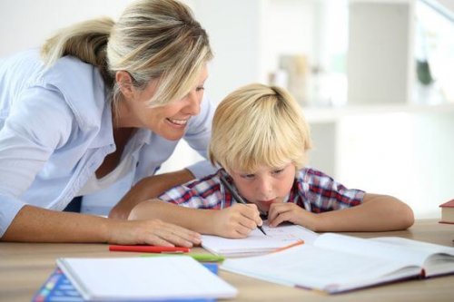 En mamma hjälper sin son med läxorna.