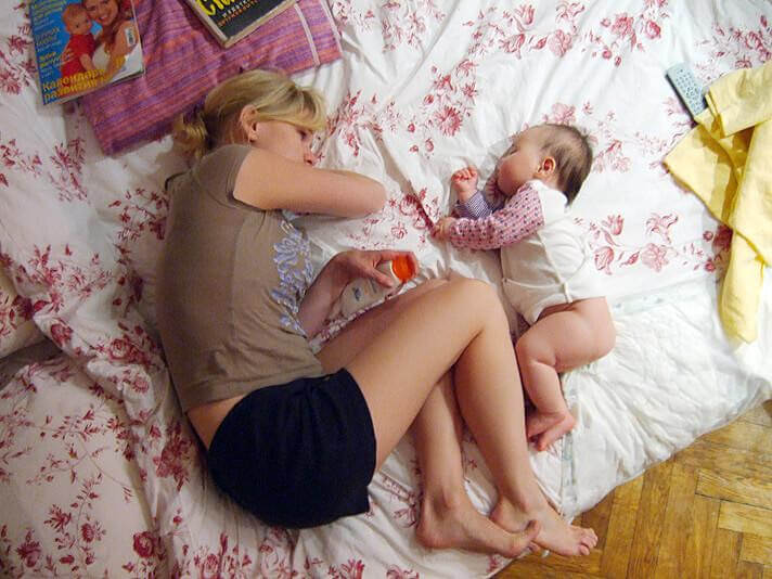 Mamma och bebis på säng