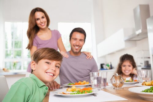 Glad familj vid middagsbordet
