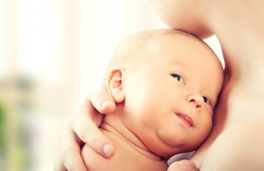 mamma håller nyfödd baby