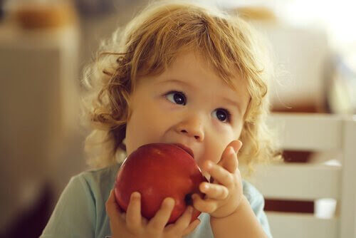 rekommenderade frukterna: flicka biter i äpple