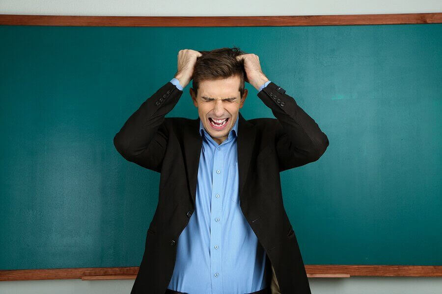 dåliga lärare: lärare framför svarta tavlan sliter sitt hår