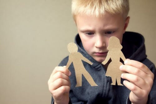 familjeband: pojke håller upp två pappersdockor