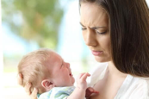 Anemi hos spädbarn: orolig mamma håller gråtande baby
