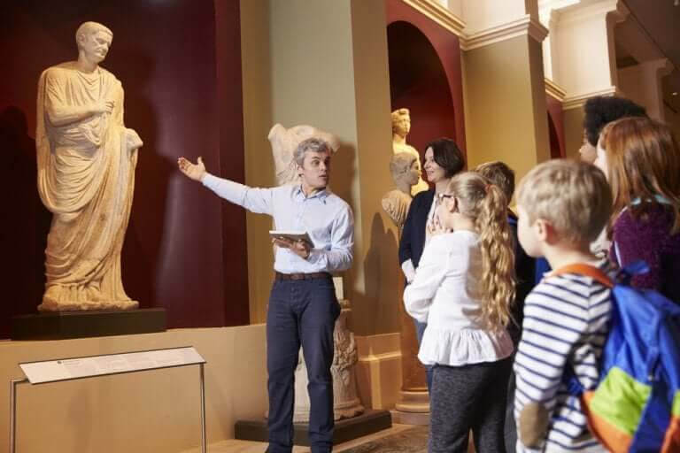 Lärare och barn tittar på konst i museum