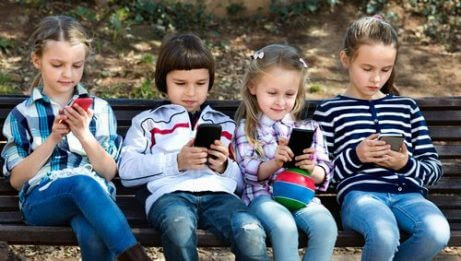 WhatsApp bland barn: barn på bänk med telefoner